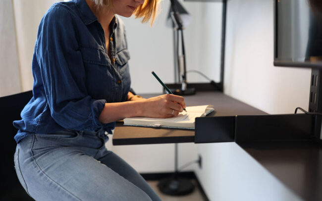 Tenant working at a desk in one of our fully furnished studio apartments in Brussels